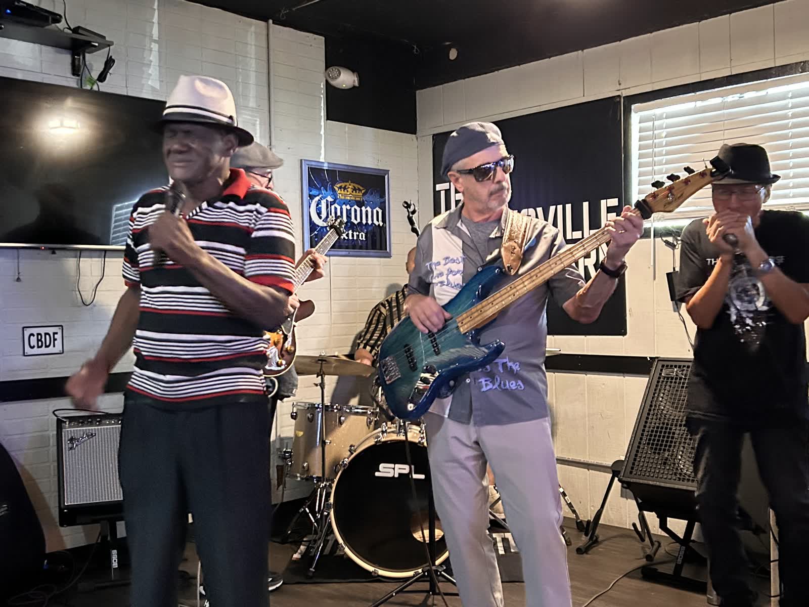 Band members performing on stage under concert lighting