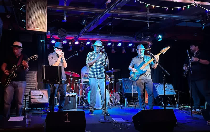 Band performing at Puck Live music venue